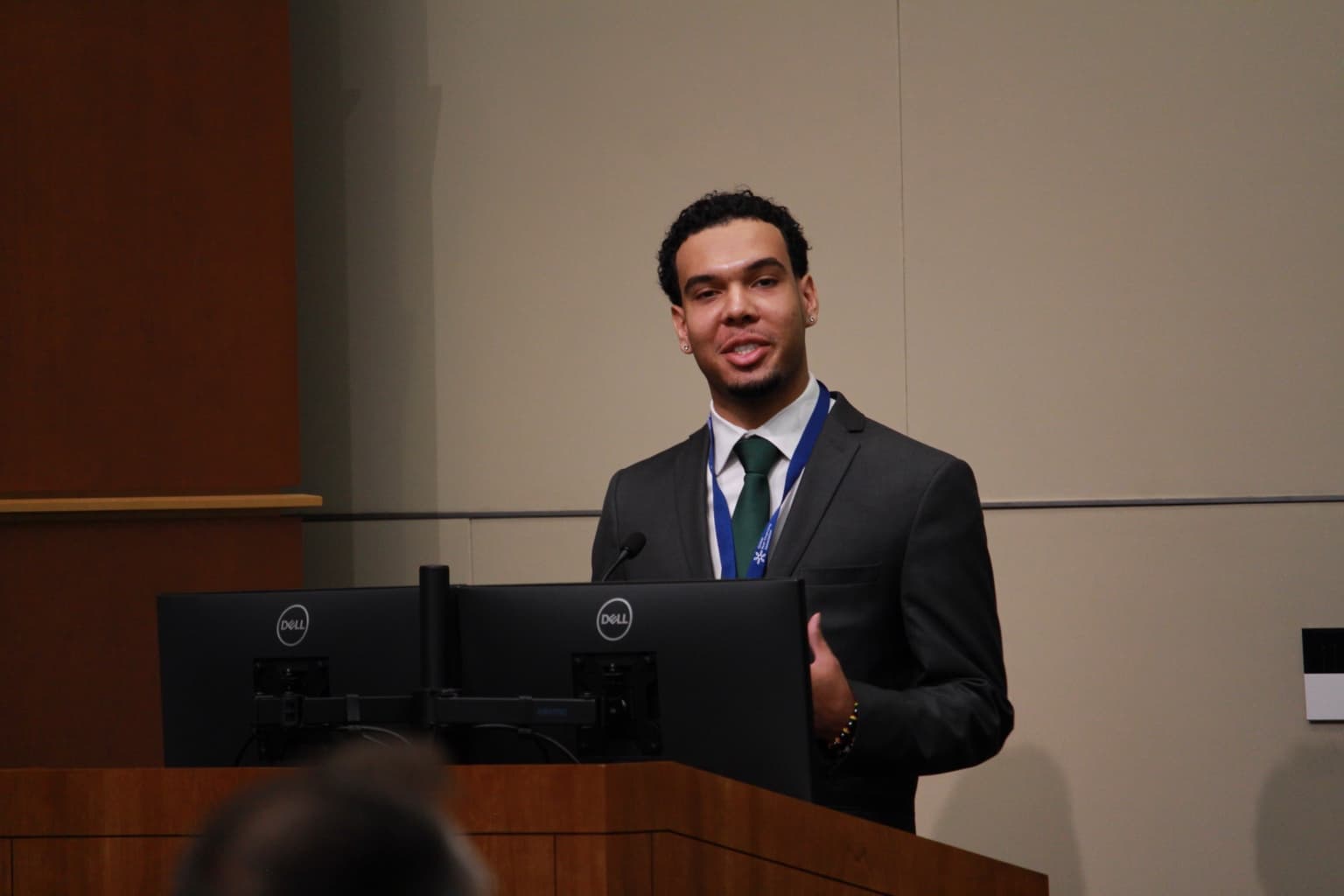Kalan Roye speaking at the podium during the GPFA Annual Member Meeting