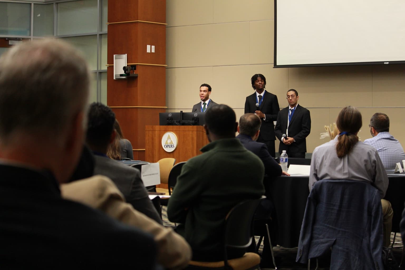 Kalan Roye presenting with Daimen Miller and Aaron Serro to GPFA members